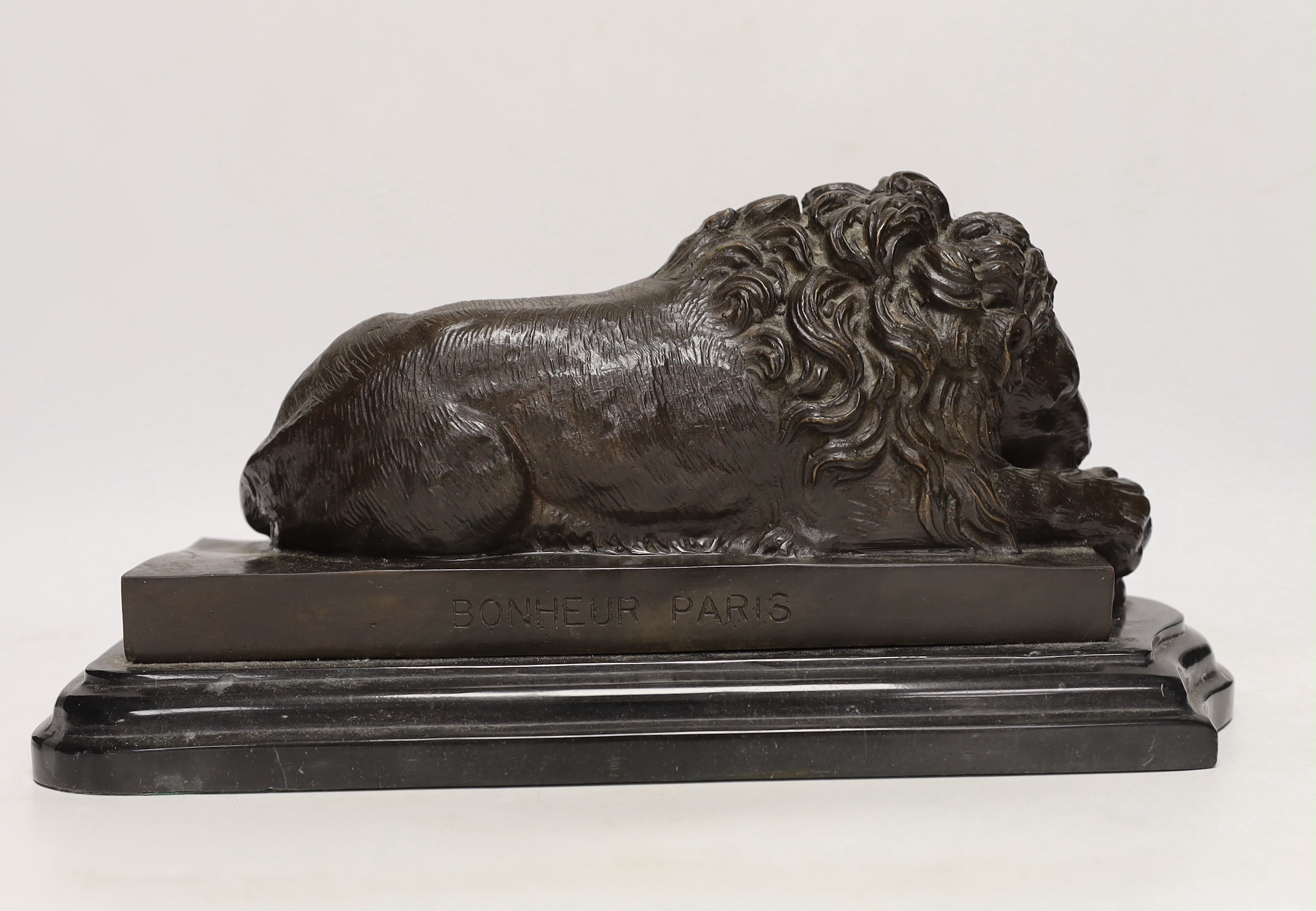 After Isadore Bonheur, a bronze figure of a recumbent lion, raised on marble base, 35cm wide